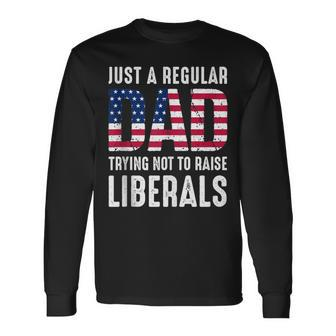 Father's Day Just A Regular Dad Trying Not To Raise Liberals Long Sleeve T-Shirt - Monsterry DE