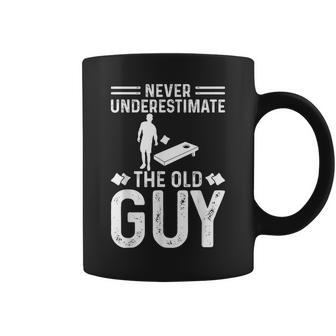 Never Underestimate The Old Guy Cornhole Baggo Bean Bag Toss Coffee Mug - Seseable