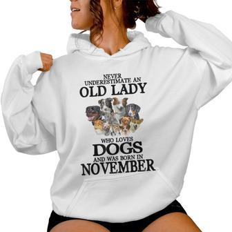 Never Underestimate An Old Lady Who Loves Dogs Born November Women Hoodie | Mazezy