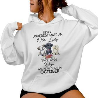 Never Underestimate An Old Lady Who Loves Dogs October Women Hoodie - Monsterry UK