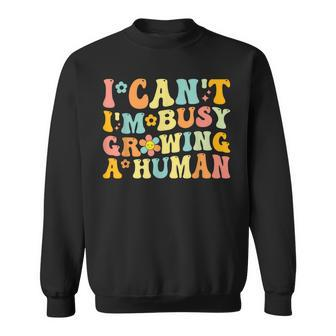 Groovy I Can't I'm Busy Growing A Human For Pregnant Women Sweatshirt - Monsterry