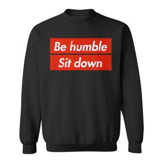 Be Humble Sit Down Expression In A Red Box Sweatshirt - Monsterry