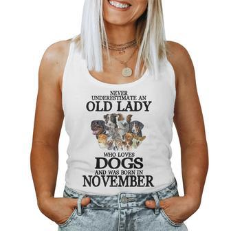 Never Underestimate An Old Lady Who Loves Dogs Born November Women Tank Top | Mazezy DE