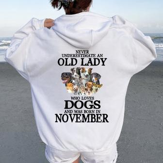 Never Underestimate An Old Lady Who Loves Dogs Born November Women Oversized Hoodie Back Print | Mazezy AU