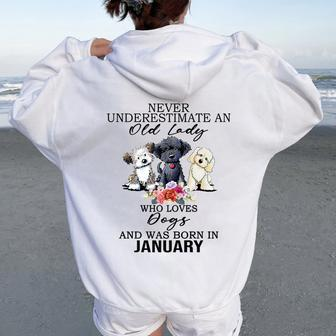 Never Underestimate An Old Lady Who Loves Dogs-January Women Oversized Hoodie Back Print - Monsterry DE