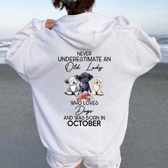 Never Underestimate An Old Lady Who Loves Dogs October Women Oversized Hoodie Back Print - Monsterry CA