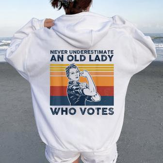 Never Underestimate An Old Lady Who Votes Feminist Women Oversized Hoodie Back Print - Monsterry AU