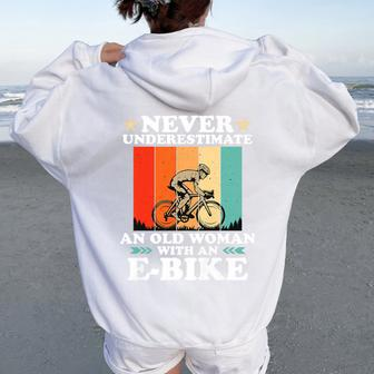 Never Underestimate An Old Woman With An E-Bike Bike Women Oversized Hoodie Back Print - Monsterry DE