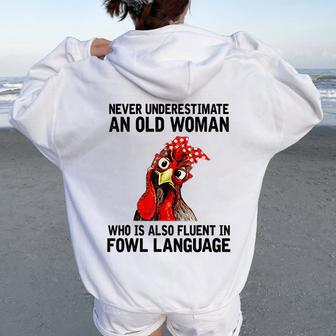 Never Underestimate An Old Woman Who Is Also Fluent Chickens Women Oversized Hoodie Back Print | Mazezy