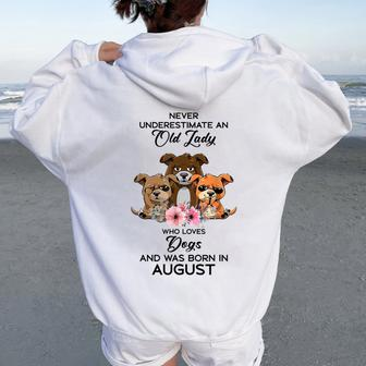 Never Underestimate An Old Woman Who Loves Dogs August Women Oversized Hoodie Back Print | Mazezy