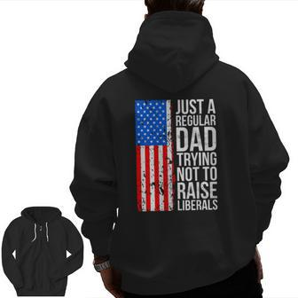 Mens Anti Liberal Just A Regular Dad Trying Not To Raise Liberals Zip Up Hoodie Back Print | Mazezy