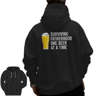 Mens Surviving Fatherhood One Beer At A Time Cool Fathers Day Zip Up Hoodie Back Print | Mazezy UK