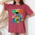 Proud Mom Of A 2024 Kindergarten Graduate Dinosaur Women's Oversized Comfort T-Shirt Crimson