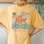In My Med Surg Era Floral Hippie Groovy Retro Daisy Nurse Women's Oversized Comfort T-Shirt Back Print Mustard