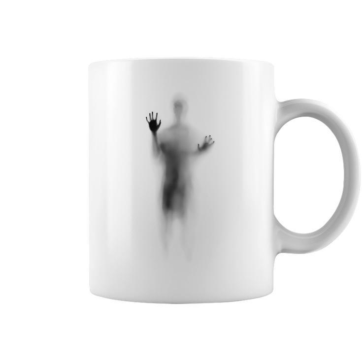 Man Lying On Glass Coffee Mug