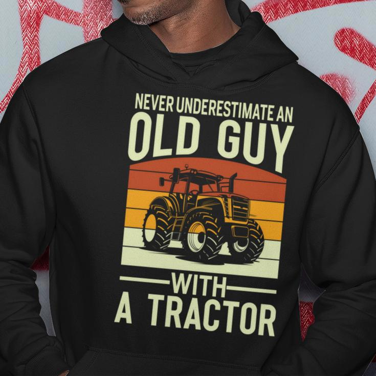 Never Underestimate An Old Guy With A Tractor Farmer Hoodie Funny Gifts