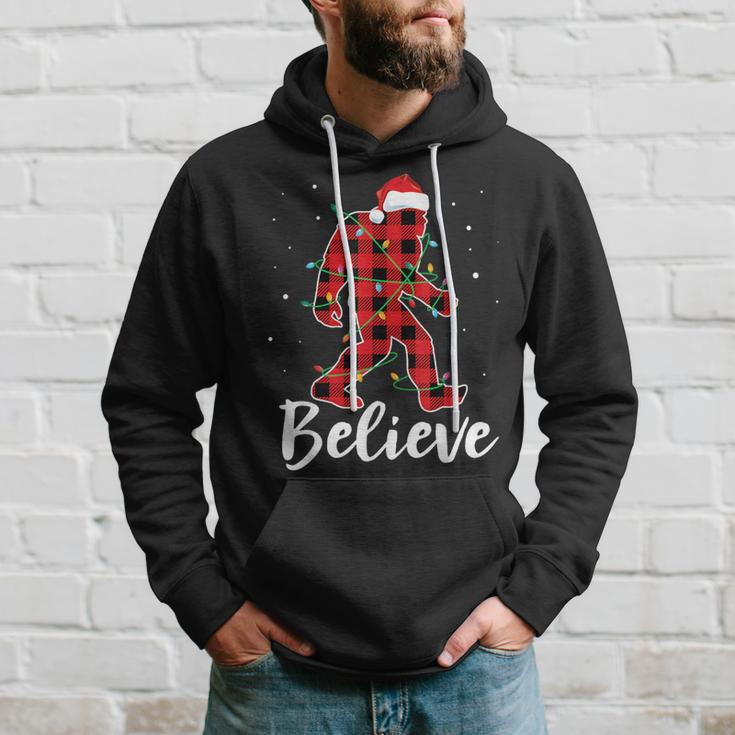 Believe Plaid Bigfoot Christmas Light Sasquatch Santa Hoodie Gifts for Him