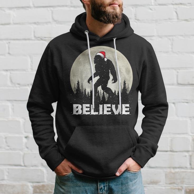 Santa Hat Bigfoot Believe Christmas Lights Rock Sasquatch Hoodie Gifts for Him