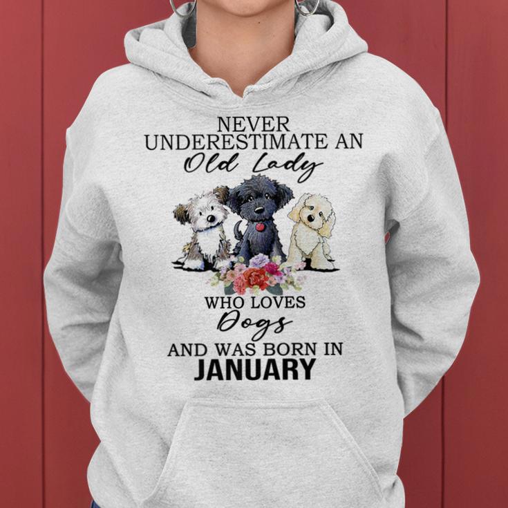 Never Underestimate An Old Lady Who Loves Dogs-January Women Hoodie