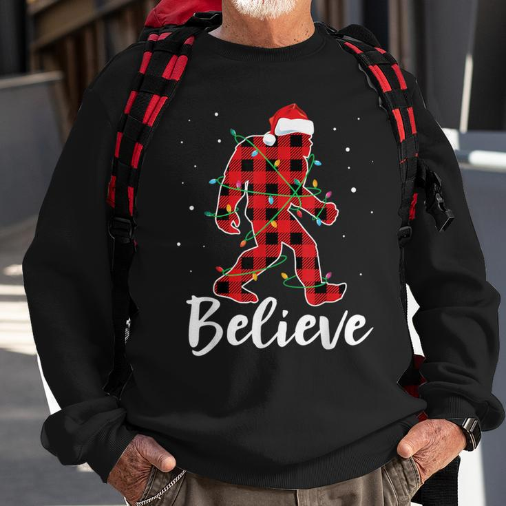 Believe Plaid Bigfoot Christmas Light Sasquatch Santa Sweatshirt Gifts for Old Men