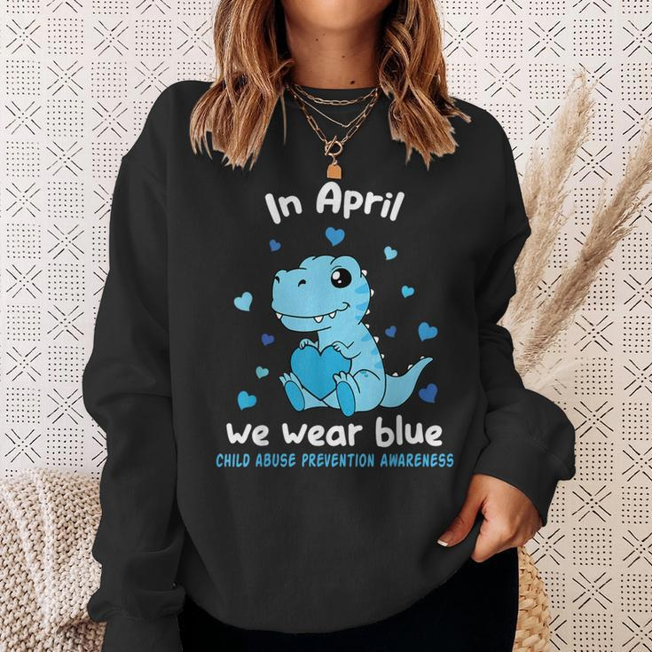 Dino In April We Wear Blue Child Abuse Prevention Awareness Sweatshirt Gifts for Her