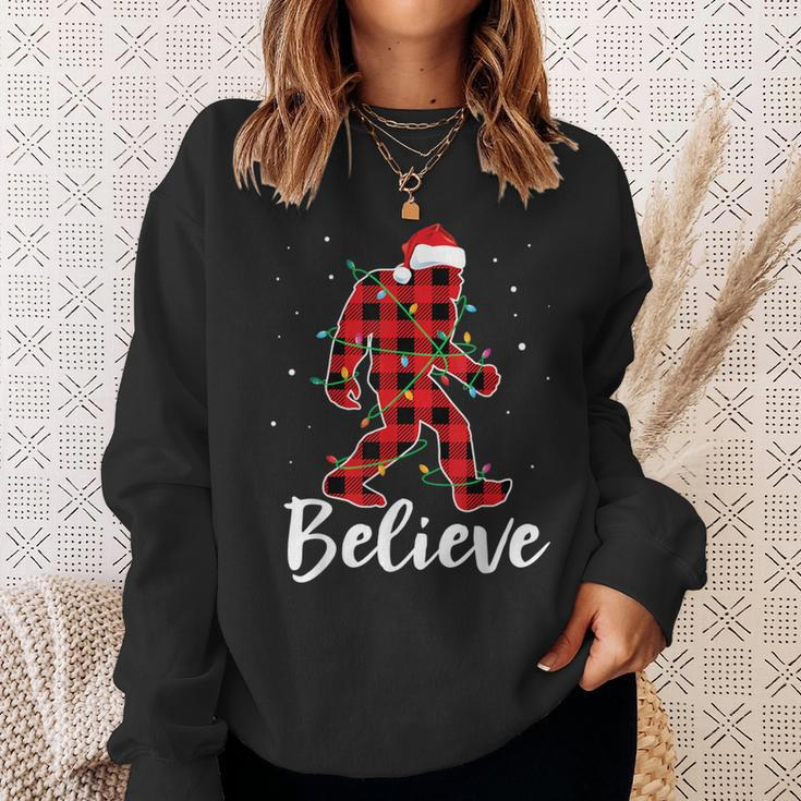 Believe Plaid Bigfoot Christmas Light Sasquatch Santa Sweatshirt Gifts for Her