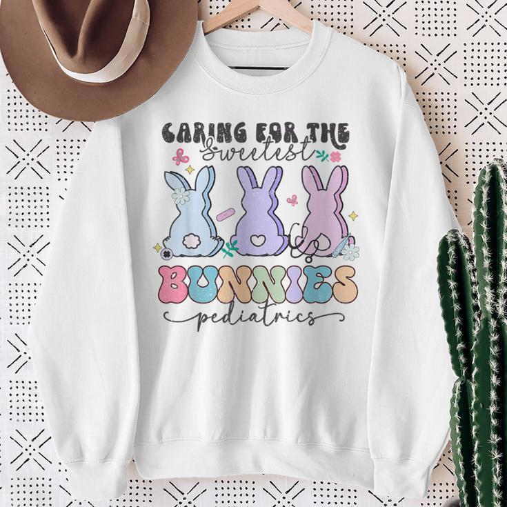 Caring For The Sweetest Bunnies Pediatric Easter Nurse Sweatshirt Gifts for Old Women