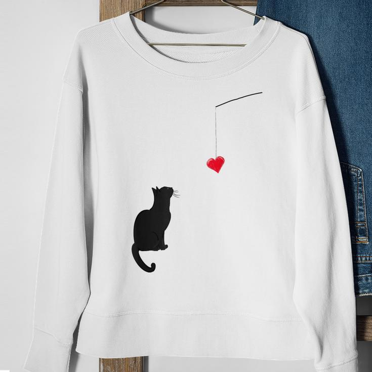 Cute Valentine's Day With A Cat Looking At A Heart Sweatshirt Gifts for Old Women