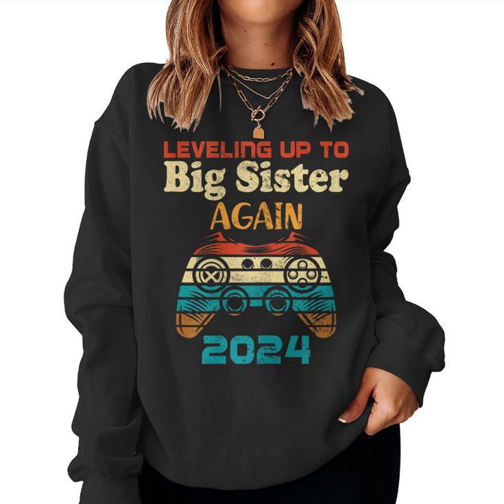 Retro Leveling Up To Big Sister Again 2024 Baby Announcement Women Sweatshirt