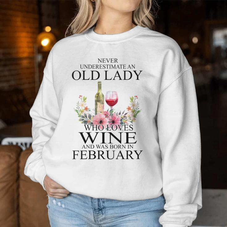 Never Underestimate An Old Woman Who Loves Wine February Women Sweatshirt Personalized Gifts