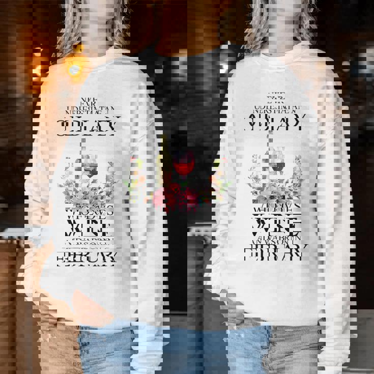 Never Underestimate An Old Woman Who Loves Wine February Women Sweatshirt Personalized Gifts