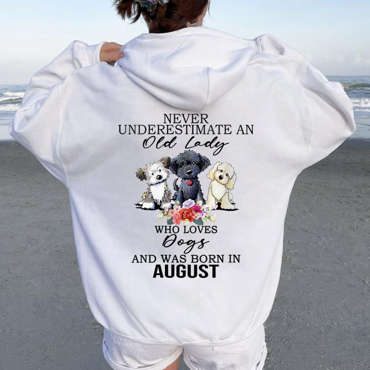 Never Underestimate An Old Lady Who Loves Dogs- August Women Oversized Hoodie Back Print