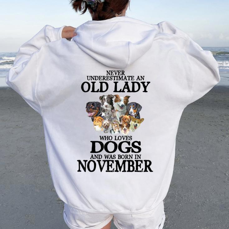 Never Underestimate An Old Lady Who Loves Dogs Born November Women Oversized Hoodie Back Print