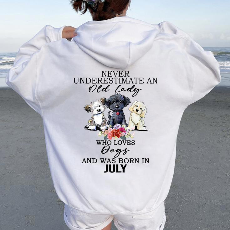 Never Underestimate An Old Lady Who Loves Dogs-July Women Oversized Hoodie Back Print