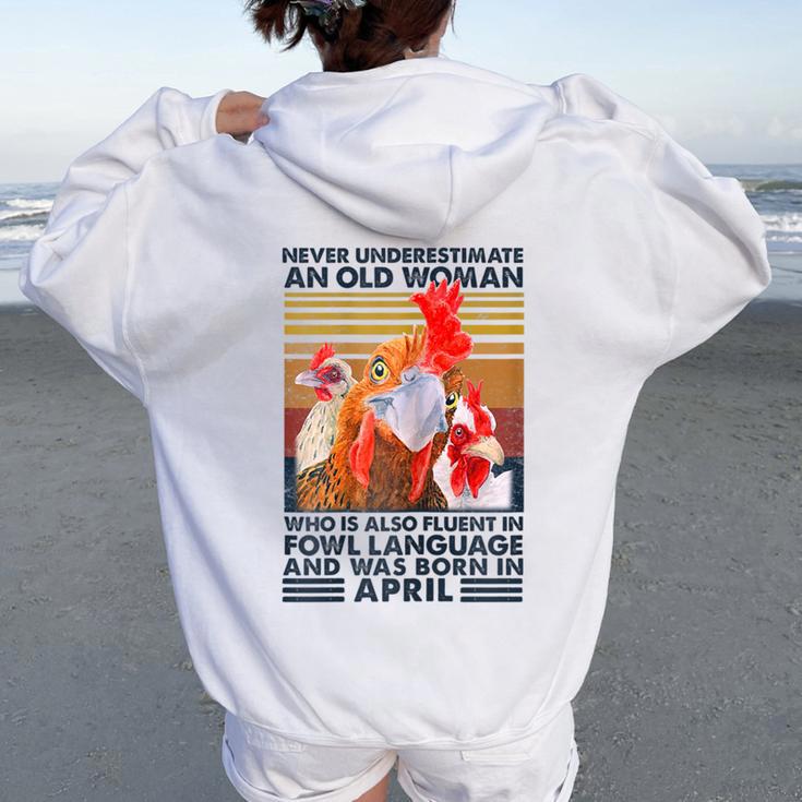 Never Underestimate Old Woman Fluent Fowl Born In April Women Oversized Hoodie Back Print