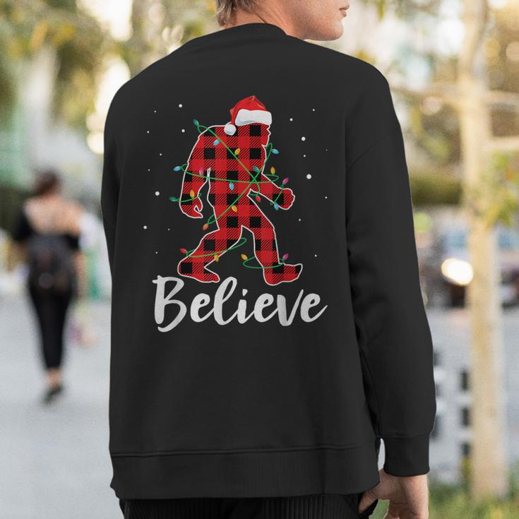 Believe Plaid Bigfoot Christmas Light Sasquatch Santa Sweatshirt Back Print
