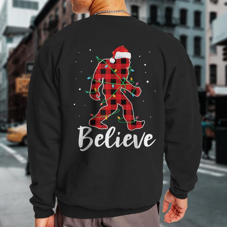 Believe Plaid Bigfoot Christmas Light Sasquatch Santa Sweatshirt Back Print