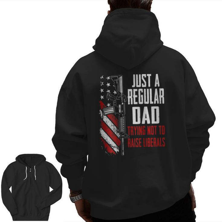 Just A Regular Dad Trying Not To Raise Liberals -- On Back Zip Up Hoodie Back Print