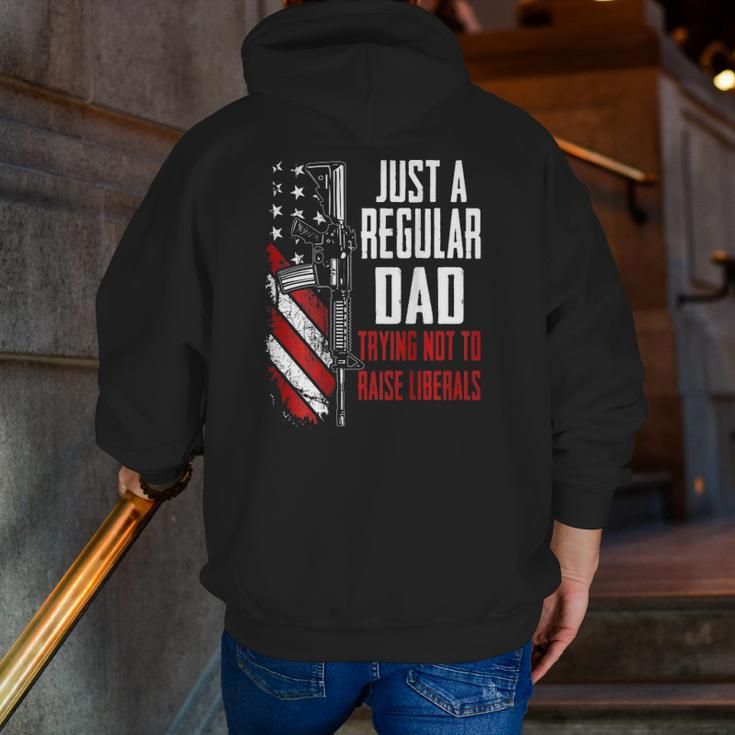 Just A Regular Dad Trying Not To Raise Liberals -- On Back Zip Up Hoodie Back Print