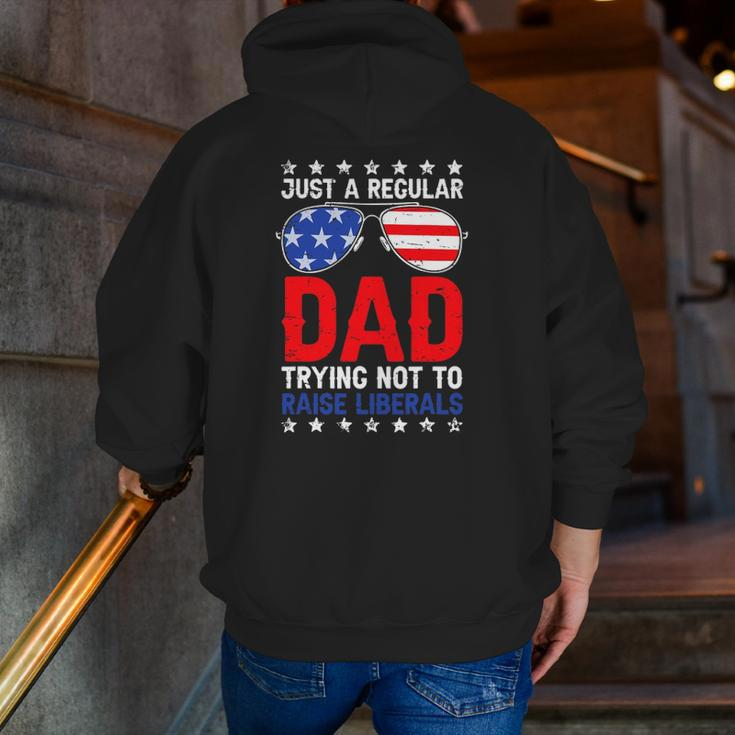 Just A Regular Dad Trying Not To Raise Liberals Voted Trump Zip Up Hoodie Back Print