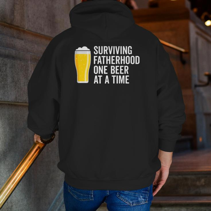 Mens Surviving Fatherhood One Beer At A Time Cool Fathers Day Zip Up Hoodie Back Print