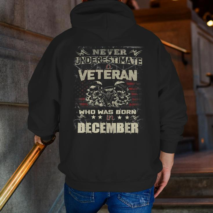 Never Underestimate A Veteran Who Was Born In December Zip Up Hoodie Back Print