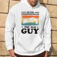 Never Underestimate The Old Guy Sack Toss Cornhole Hoodie Lifestyle