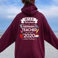 Never Underestimate A German Teacher Who Survived 2020 Women Oversized Hoodie Back Print Maroon